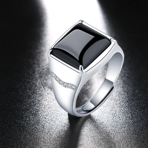 Macro shot of men's square black obsidian stone ring with side diamond accents