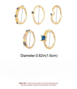 Detail view of 5-piece gold-plated copper ring set with blue and white zircon stones