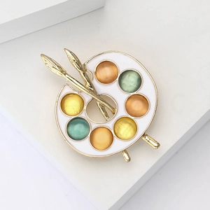 Luxurious artist palette brooch in gold alloy with colorful cat eye stones and brushes