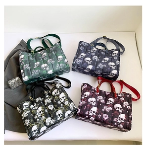 Quilted tote bags with skull and floral prints in green, blue, black, and burgundy