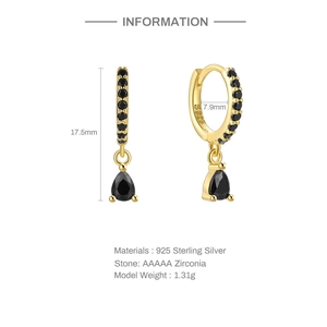 Macro view of gold 925 sterling silver drop earrings with black zirconia stones