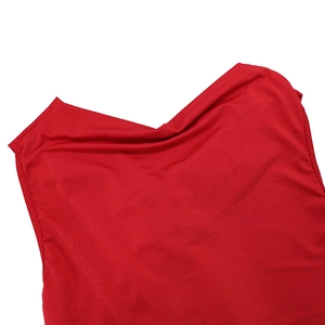 Detail of red backless dress showing soft cowl neck drape and silky fabric texture