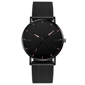 Detail view of the black metal mesh strap and rose gold markers on this quartz watch