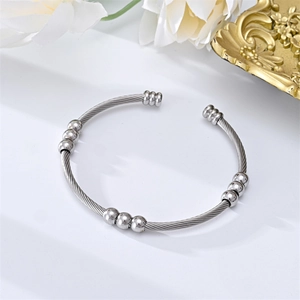 Minimalist stainless steel cable cuff bangle with polished beads and twisted wire rope design