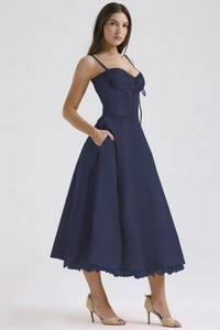 Detail of dark blue floral midi dress featuring lace trim hem and silky satin fabric