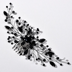 Detailed view of handmade bridal hair comb with emerald crystals and black wire craft