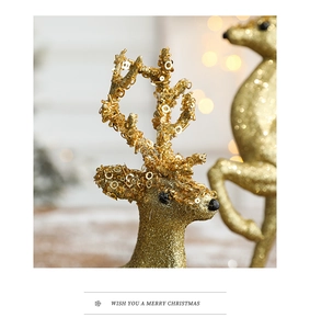 Macro view of a golden sequin reindeer decoration with warm festive lighting background