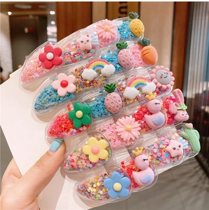 Macro shot of colorful glitter hair clips with cute fruit and animal patterns