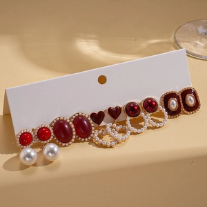 Ten-piece set of vintage pearl heart and geometric resin earrings on white display card