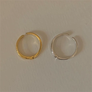 Close-up of minimalist adjustable gold and silver bamboo style stackable rings