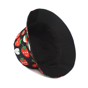 Detail shot of strawberry pattern bucket hat featuring black inner lining and reinforced brim