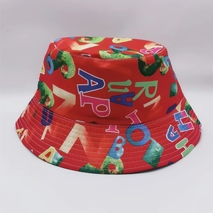 Detailed close-up of red bucket hat with colorful all-over alphabet letter print