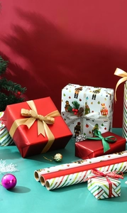 Close-up of Christmas gift wrapping paper featuring nutcracker motifs and festive ribbons