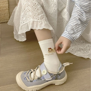 White cotton crew socks featuring cartoon puppy embroidery and Dog Cake lettering style