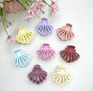 Detailed set of eight matte shell shaped hair claws in various elegant pastel colors