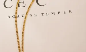 Close-up of golden stainless steel curb chain with delicate metal link texture