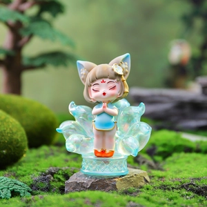 Macro detail of 九尾狐仙 Nine-Tailed Fox figure in blue outfit on moss background