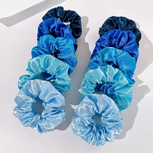 Set of 10 gradient blue satin scrunchies displayed neatly on a white background