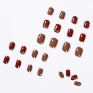 Glossy Rembrandt red and brown press-on nails set with elegant gold foil glitter accents
