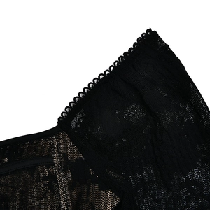 Détail macro de dentelle florale noire avec des finitions délicates à bord festonné