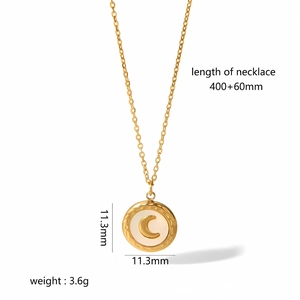 Detail view of 18k gold celestial moon pendant with shell inlay and product dimensions