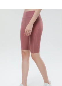 Detailed side view of high-waisted yoga shorts in dusty rose with ergonomic seams