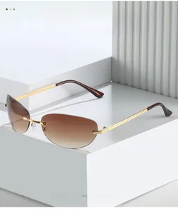 Detail of rimless sunglasses with gradient brown lenses and slim gold metal temples