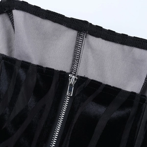 Detail of black velvet tube top showing metal zipper closure and grey contrast lining