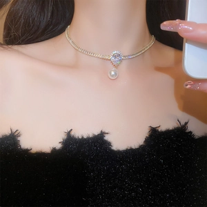 Detail of gold-plated necklace featuring a waterdrop zircon pendant and hanging pearl