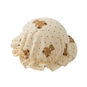 Infant cotton gauze beanie featuring bear print and ruffled edges on cream fabric