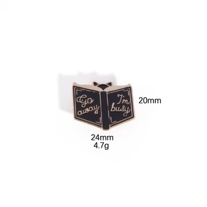 Detailed view of black cat book enamel pin with dimensions 20mm height and 24mm width
