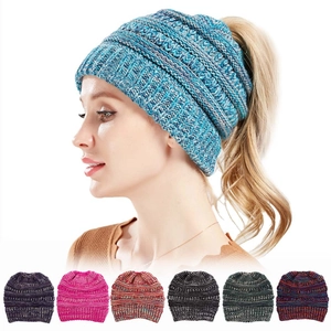 Women's cable knit ponytail beanie hat in various colors with a soft warm finish