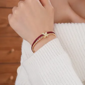 Double-layer gold plated bracelet with woven leather rope and pavé zircon X-cross link