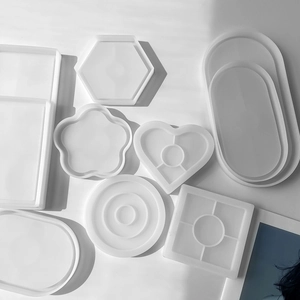 Flat lay of translucent silicone coaster molds in various geometric shapes for DIY resin art