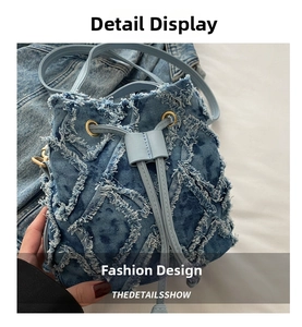 Detail of light blue denim bucket bag with frayed quilted patterns and drawstring closure