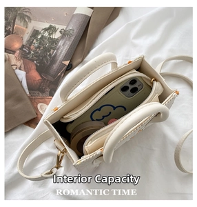 Internal capacity of the woven crossbody bag showing phone and compact powder space