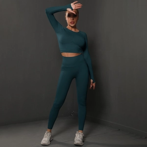 Detail of dark teal seamless yoga set with thumbhole sleeves and high waist leggings