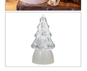 Detail of USB power cable and a glowing Christmas tree crystal ball music lamp night light