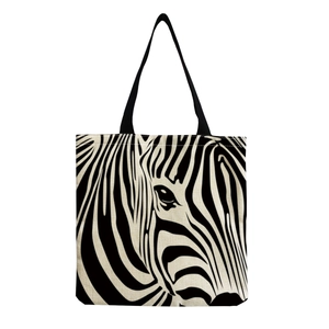 Close-up of zebra pattern print on canvas tote bag with black woven handles