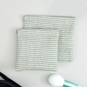 Close-up of woven PU leather organizer bags with automatic spring closure for accessories