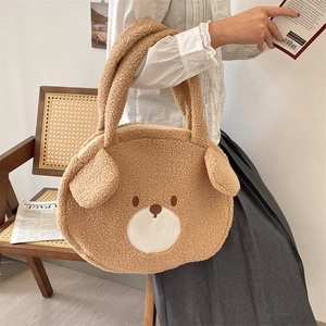 Detail showing the fluffy brown bear plush tote bag with a secure zipper closure on top