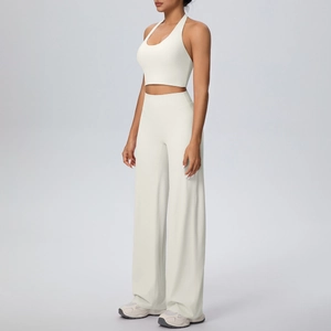 Detail of high-stretch halter sports top and wide-leg yoga pants in beige set