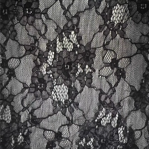 Elegant women's black straight trousers featuring intricate lace patchwork and floral texture