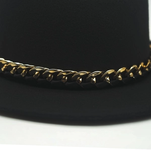 Close-up of black felt fedora hat featuring a chunky gold metal chain link detail