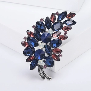 Elegant vintage leaf brooch with deep blue and purple crystals on silver alloy base