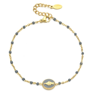 Detail of gold stainless steel bracelet with gray beads and religious medal charm