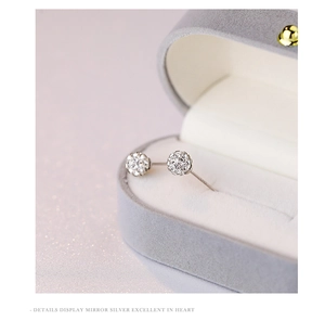 Macro view of S925 sterling silver ball stud earring with zircon inlay in a jewelry box