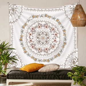 Detailed pink and brown mandala tapestry wall hanging in a cozy boho living room setup