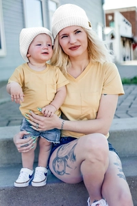 Detail of ginger yellow V-neck knitted cotton t-shirts with front pocket for family