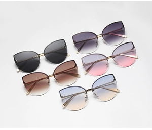 Detailed row of six frameless cat-eye sunglasses in various gradient lens colors